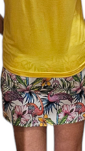 Load image into Gallery viewer, a woman wearing a yellow shirt and floral shorts
