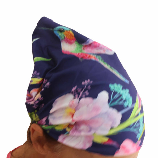 Side view of woman wearing navy Hummingbird floral-print headband