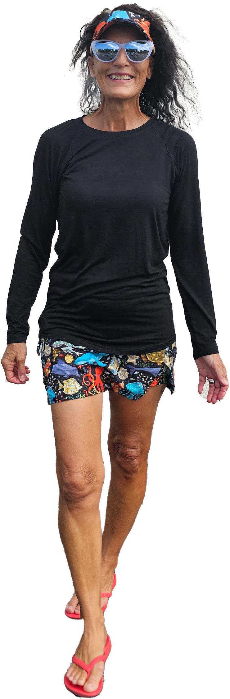 a woman in a black shirt and colorful shorts