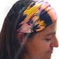 a woman with a colorful Lavender island bandana headband head wrap on her head