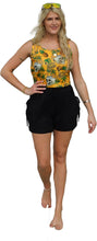 Load image into Gallery viewer, a woman in a yellow top and black shorts
