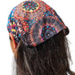 a close up of a person wearing a mandala headband 