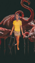 Load image into Gallery viewer, a woman standing in front of a group of flamingos
