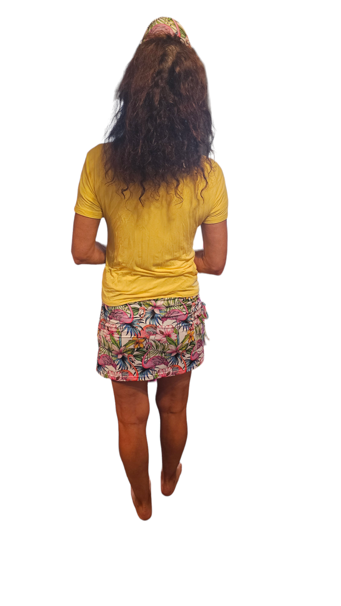 a woman in a yellow shirt and colorful skirt
