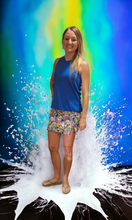 Load image into Gallery viewer, a woman standing in front of a painting of a wave
