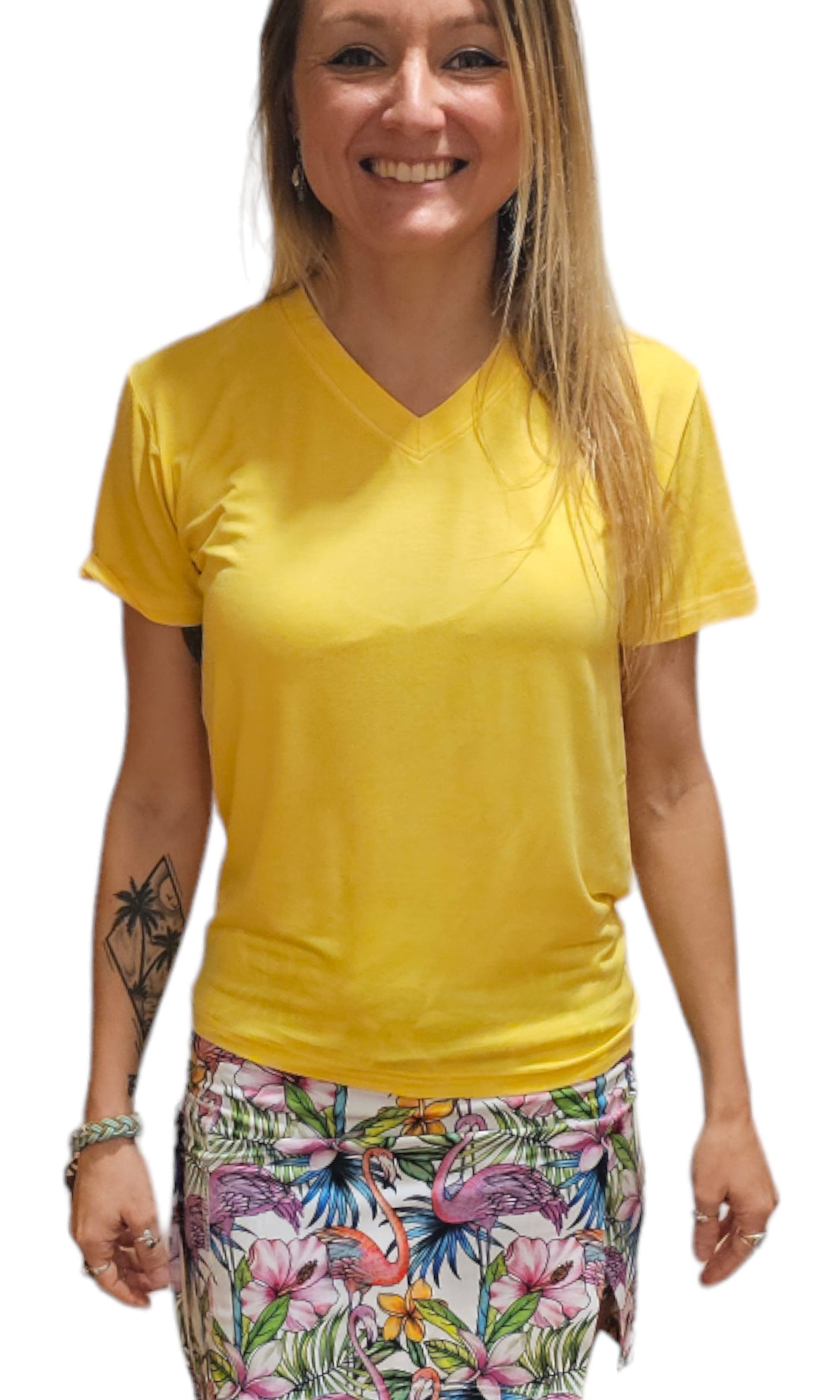 a woman wearing a yellow shirt and floral print skirt