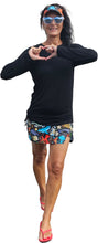 Load image into Gallery viewer, a woman in a black shirt and colorful shorts
