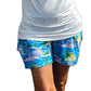 a woman in blue shorts and a white shirt giving a thumbs up