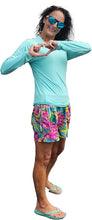 Load image into Gallery viewer, a woman in a blue shirt and colorful shorts
