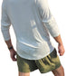 a man in a white shirt and green shorts