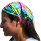 a woman with a colorful head wrap on her head