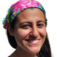 a woman with a colorful headband smiles for the camera