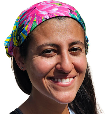 a woman with a colorful headband smiles for the camera