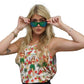 a woman in a hula girl hawaiian design tank top is holding up her sunglasses