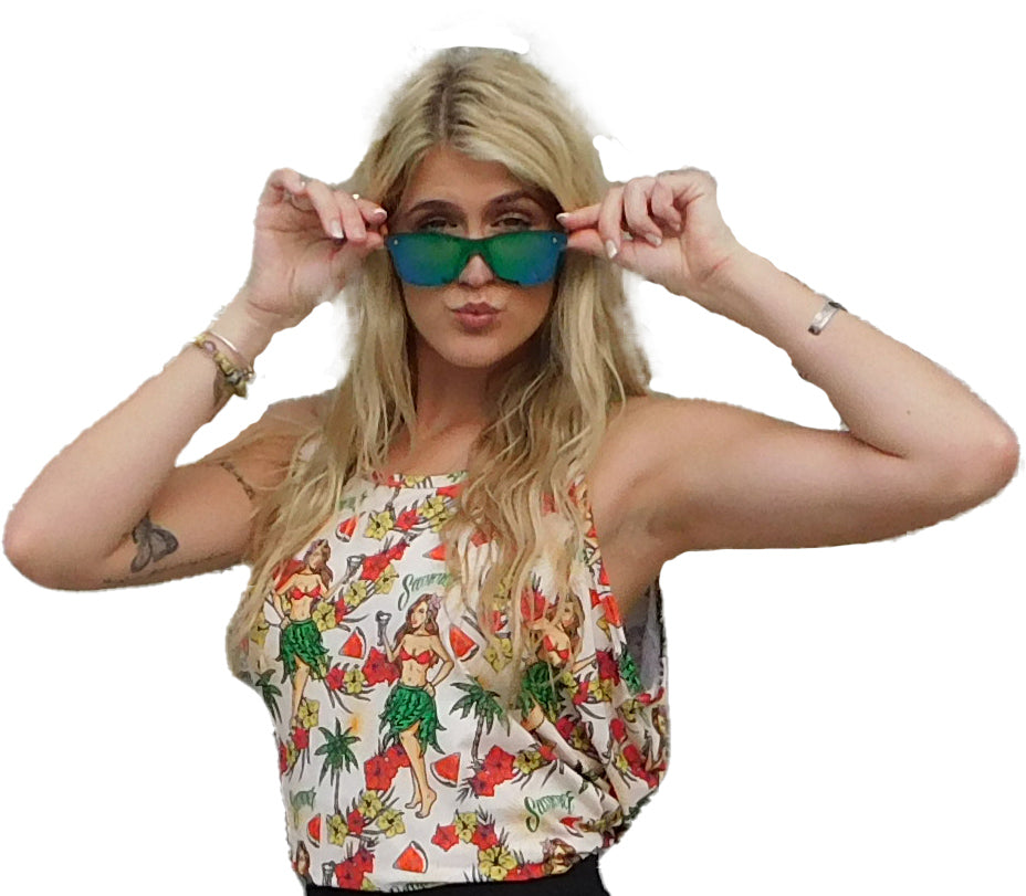 a woman in a hula girl hawaiian design tank top is holding up her sunglasses