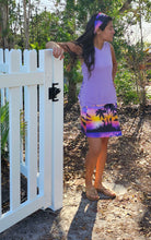 Load image into Gallery viewer, a woman standing next to a white fence wearing a Lavender island wrap and matching bandana headband 
