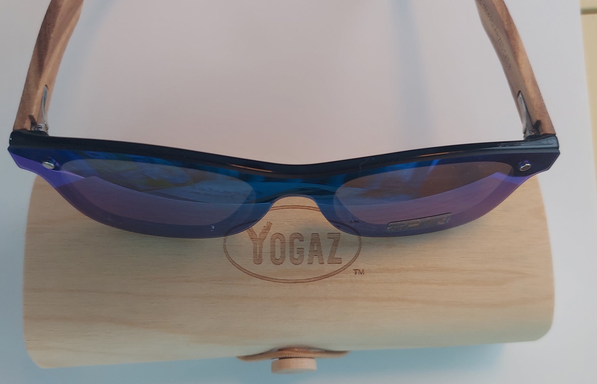 a pair of sunglasses sitting on top of a wooden stand